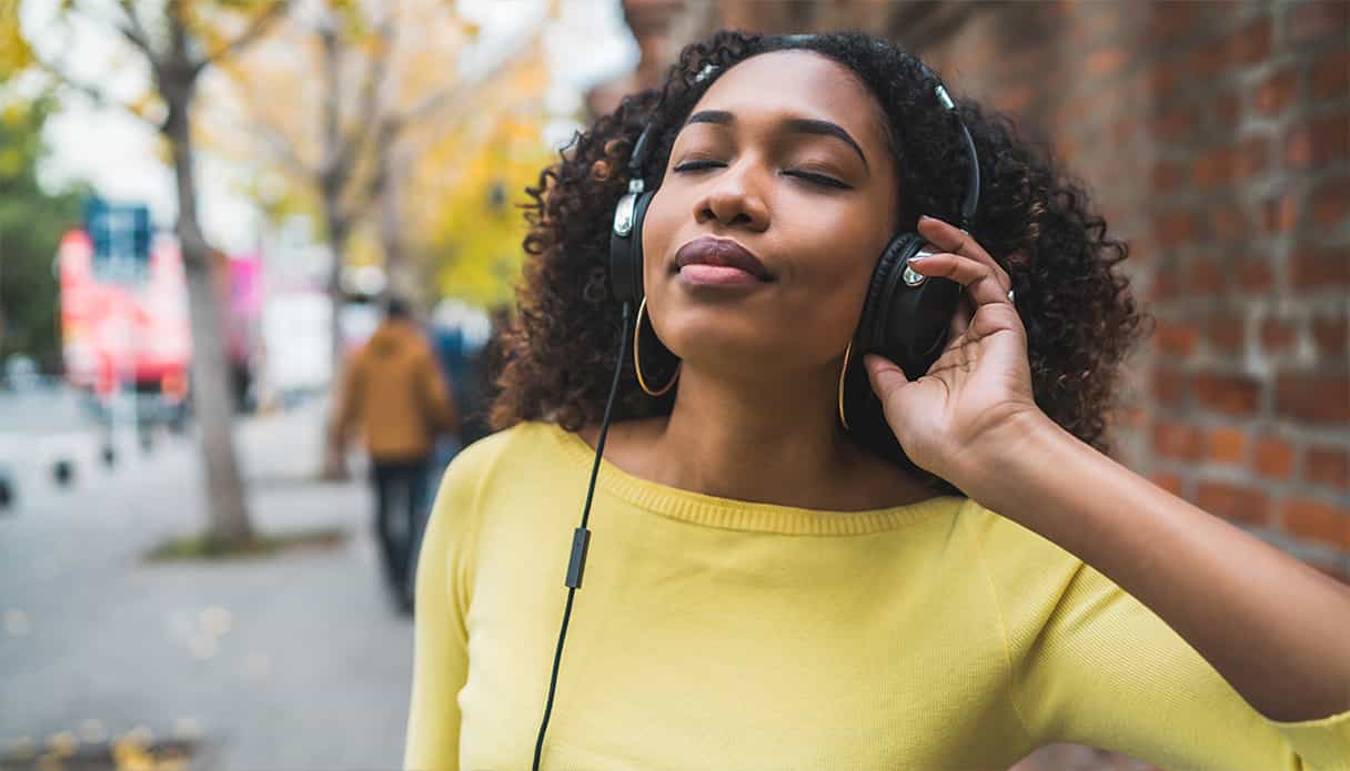 Le modèle féminin porte un casque sans fil autour de son cou et le modèle masculin porte un casque filaire.